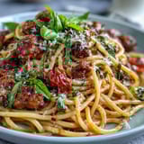 Piping hot Italian Drunken Noodles with shrimp, fresh basil, and grated Parmesan cheese on a white ceramic plate.