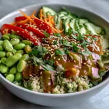 Vibrant vegan Thai Coconut Quinoa Bowl served chilled, featuring colorful shredded cabbage, edamame, and fresh cilantro garnish.