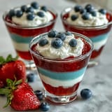 Festive layered Jello dessert with bold red, white, and blue stripes, chilled and ready for a fun, colorful treat.