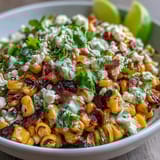 Creamy and tangy Mexican street corn salad featuring smoky grilled corn, zesty lime dressing, and crumbled Cotija cheese for a perfect summer side.  