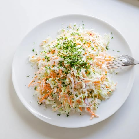 Freshly grated sweet-tart apple adds vibrant color and crunch to this Coleslaw with Apple side, ideal for pairing with grilled chicken or sandwiches.