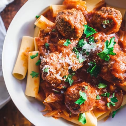Tender, golden turkey meatballs simmering in a bubbling tomato sauce, ready to serve over pasta or fluffy white rice for dinner.