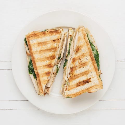 Grilled chicken and fresh spinach layered with melty mozzarella on crusty bread, served warm from the panini press.