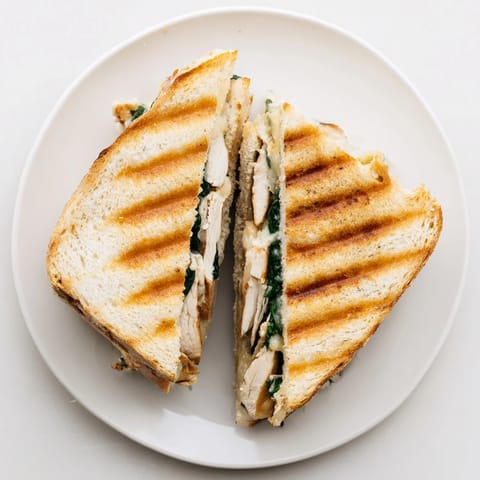 Juicy grilled chicken, spinach, and Parmesan in a golden, garlic-butter toasted Grilled Chicken Spinach Panini.