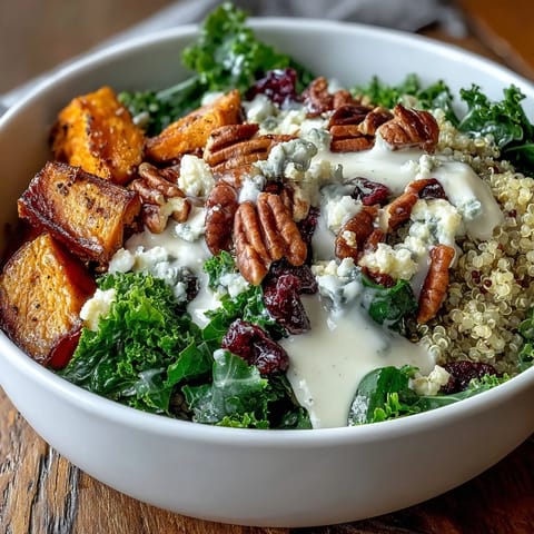 A bright drizzle of lemon tahini dressing adds zest, with pecans, cranberries, and blue cheese crumbles.