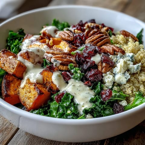 Golden roasted sweet potatoes and massaged kale sit atop fluffy quinoa in a Harvest Kale Quinoa Bowl.