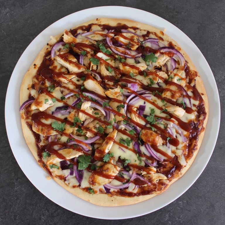 Homemade Chicken BBQ Pizza featuring tangy barbecue sauce, tender grilled chicken, and melty cheese, served hot for family dinner.
