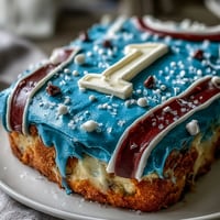 Graduation sports jersey cake with fondant details and personalized number, perfect for celebrating a graduate's big day.